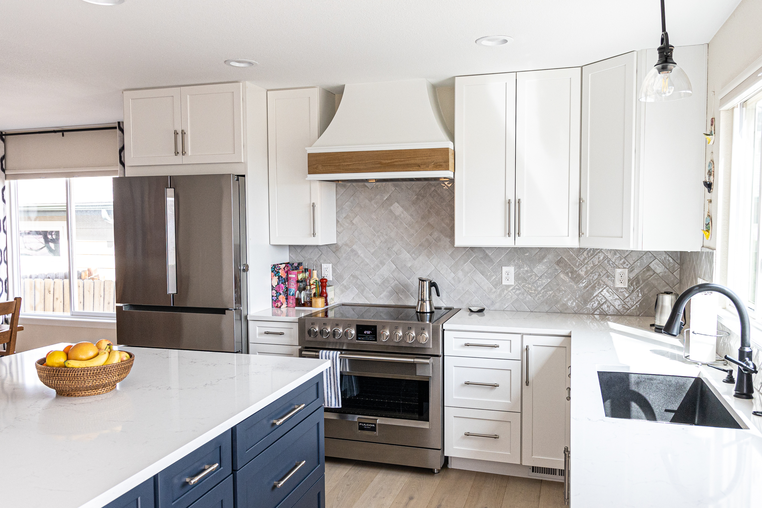 Bright, white kitchen with island and bar seating